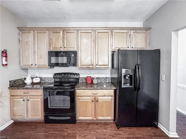 1004 Christiana Cir, Portsmouth, VA 23703 - kitchen featuring dark wood-style floors, dark stone counters, baseboards, and black appliances