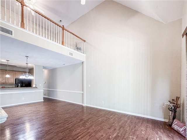 1004 Christiana Cir, Portsmouth, VA 23703 - unfurnished living room with baseboards, visible vents, high vaulted ceiling, and dark wood-type flooring