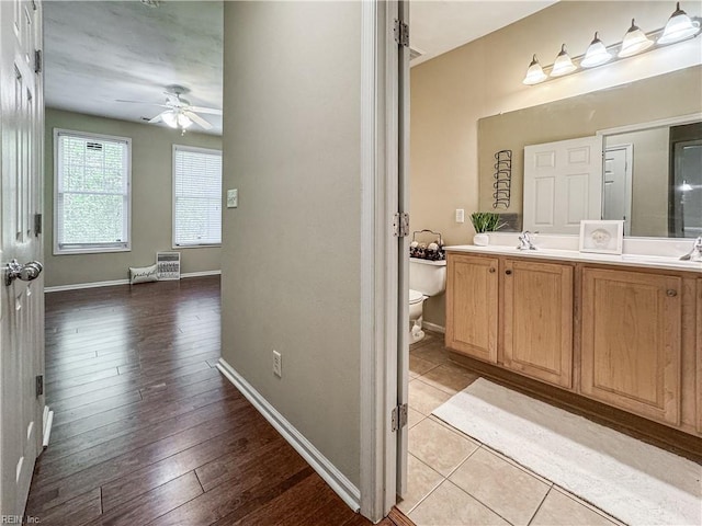 1004 Christiana Cir, Portsmouth, VA 23703 - bathroom featuring a sink, ceiling fan, double vanity, baseboards, and toilet