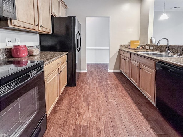 1004 Christiana Cir, Portsmouth, VA 23703 - kitchen with light brown cabinetry, stone countertops, a sink, dark wood-type flooring, and black appliances