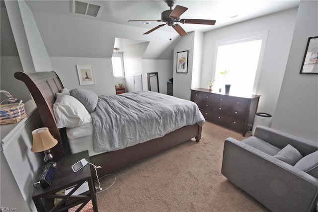 carpeted bedroom featuring vaulted ceiling, visible vents, and a ceiling fan