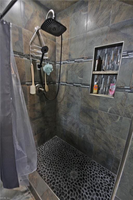 full bath featuring a tile shower