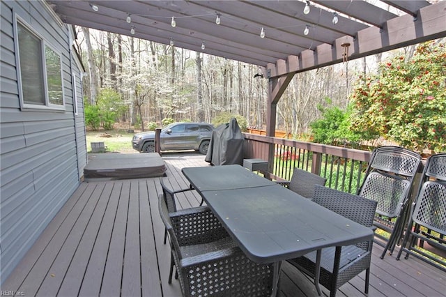 wooden terrace with a pergola and outdoor dining space