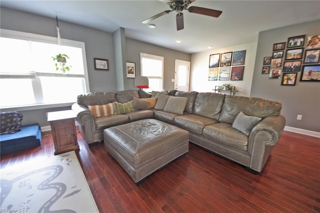 living area featuring ceiling fan, baseboards, and wood finished floors