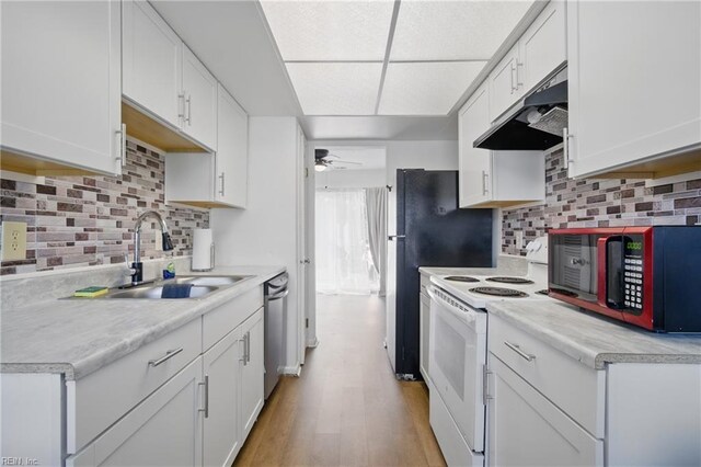 kitchen featuring tasteful backsplash, a sink, light countertops, under cabinet range hood, and white electric stove