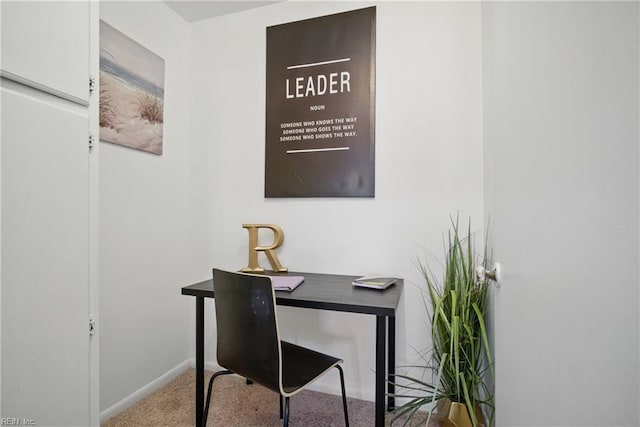 carpeted office featuring baseboards
