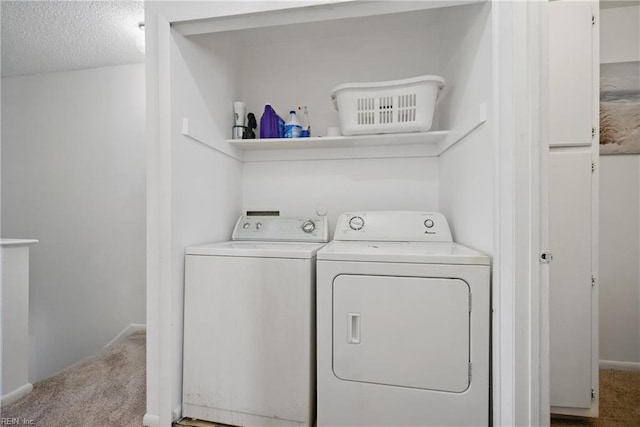 laundry room featuring a textured ceiling, independent washer and dryer, laundry area, and carpet floors