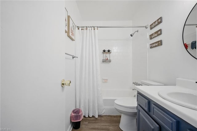 full bathroom featuring shower / bath combo, wood finished floors, toilet, and vanity