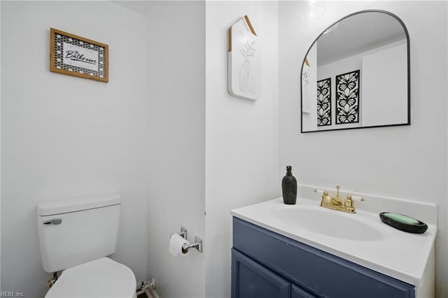half bathroom featuring toilet and vanity