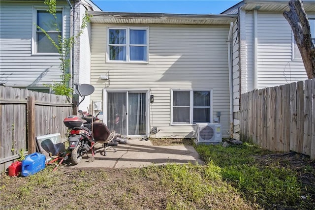 back of property featuring a fenced backyard, a patio area, and ac unit