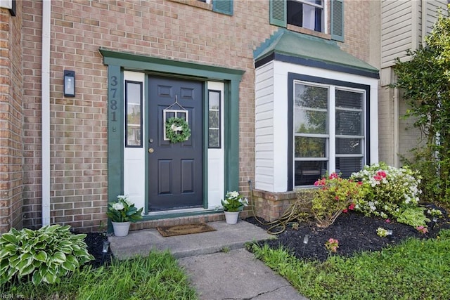 property entrance with brick siding