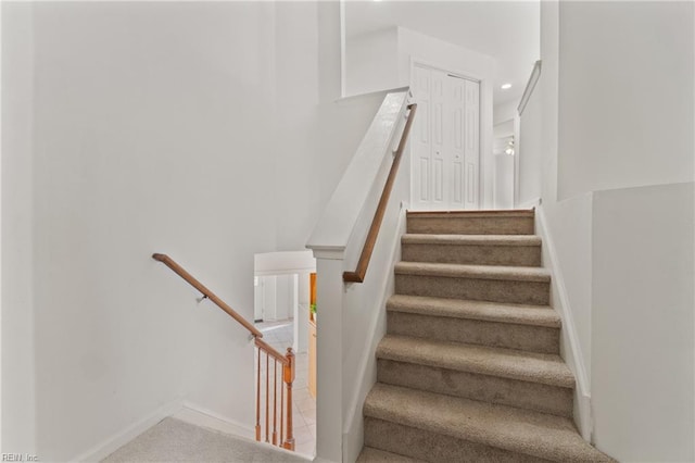 stairway with recessed lighting and baseboards