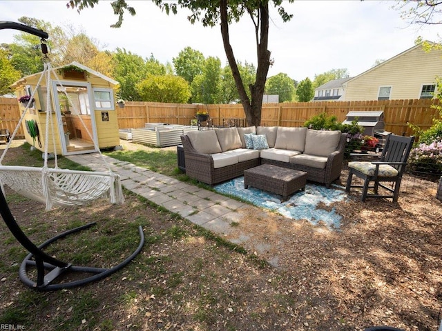 view of patio featuring a fenced backyard, an outdoor hangout area, and an outdoor structure
