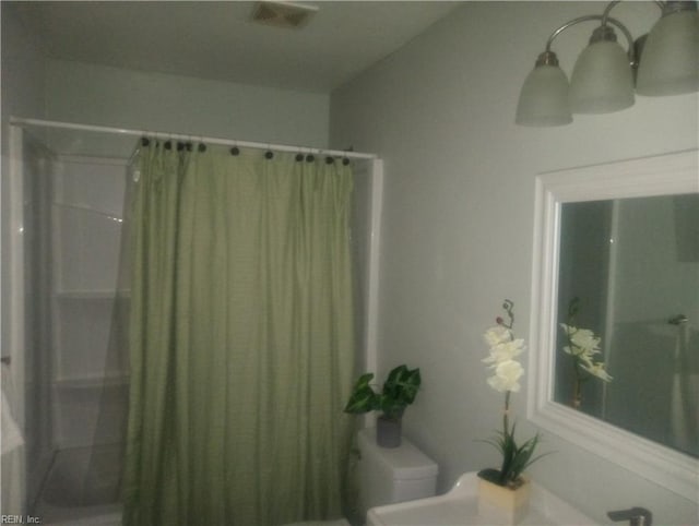 bathroom with toilet and visible vents
