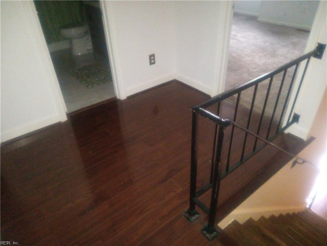 stairs with wood finished floors and baseboards