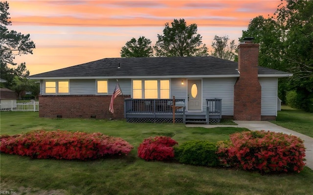 back of house featuring fence, crawl space, a yard, and a deck