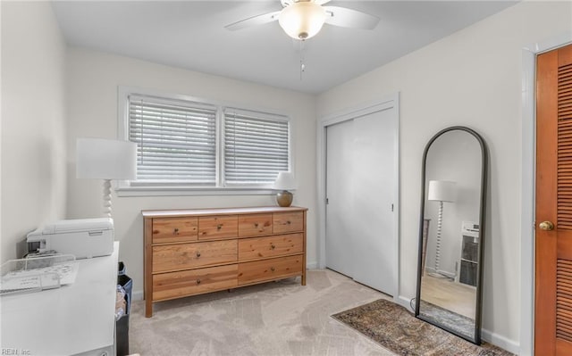 bedroom featuring two closets, a ceiling fan, and light colored carpet