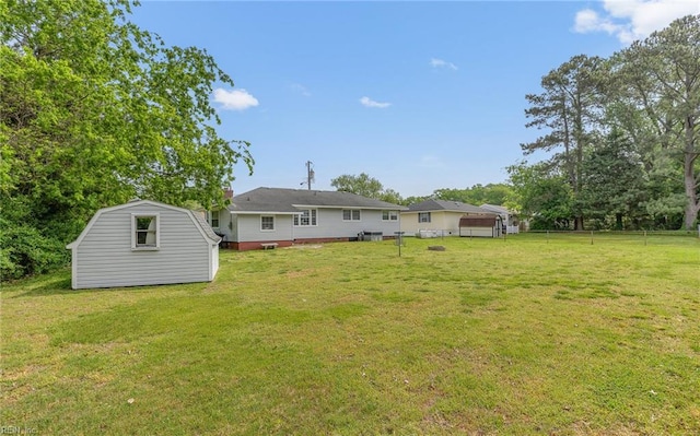 view of yard featuring a storage shed and an outdoor structure
