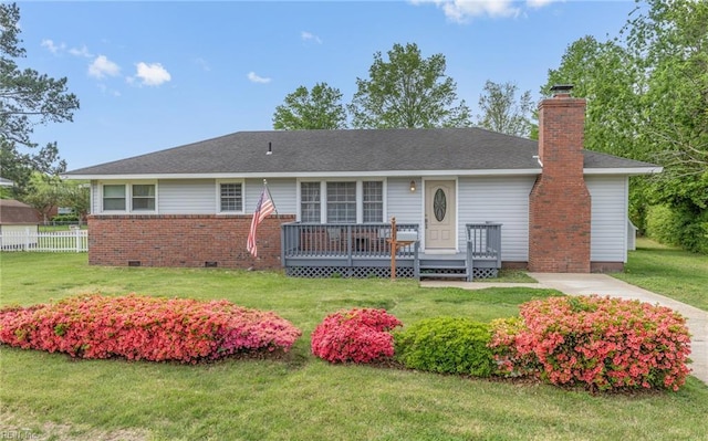 single story home featuring a chimney, a front lawn, a deck, fence, and brick siding