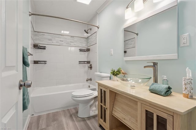 full bath featuring wood finished floors, toilet,  shower combination, and vanity
