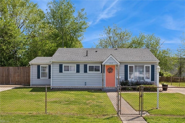 view of front of home featuring a front yard, a fenced front yard, and a gate