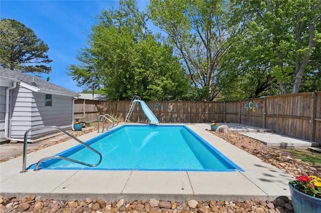 view of swimming pool with a fenced in pool, a patio, a fenced backyard, and a water slide