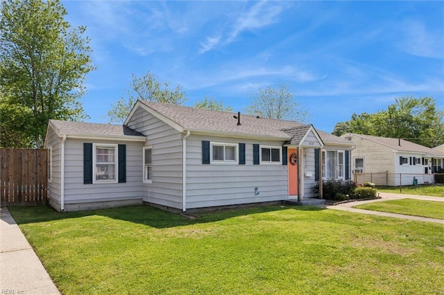 view of front facade with a front yard and fence
