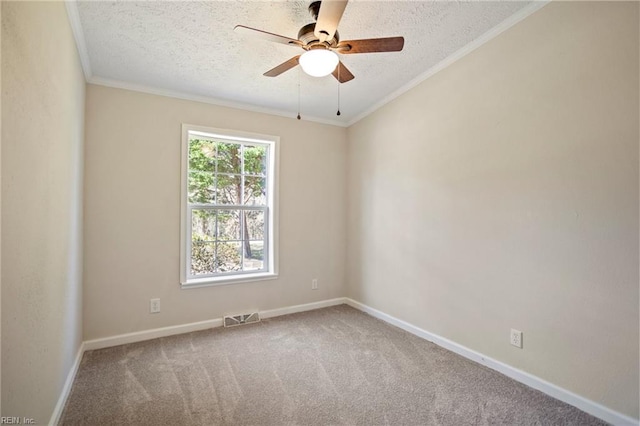 empty room featuring crown molding, a textured ceiling, and visible vents