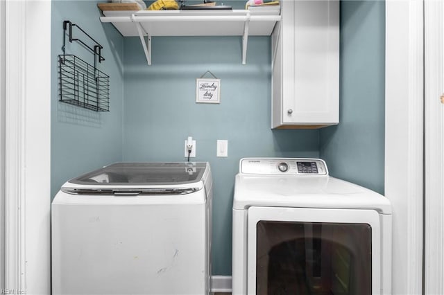laundry area featuring washing machine and dryer and cabinet space