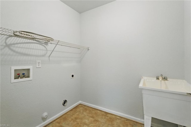 clothes washing area featuring hookup for an electric dryer, gas dryer hookup, baseboards, hookup for a washing machine, and laundry area