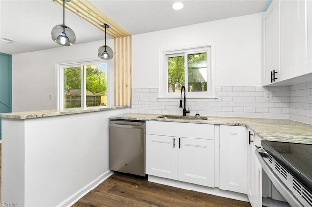 kitchen with a wealth of natural light, light stone countertops, stainless steel appliances, and a sink
