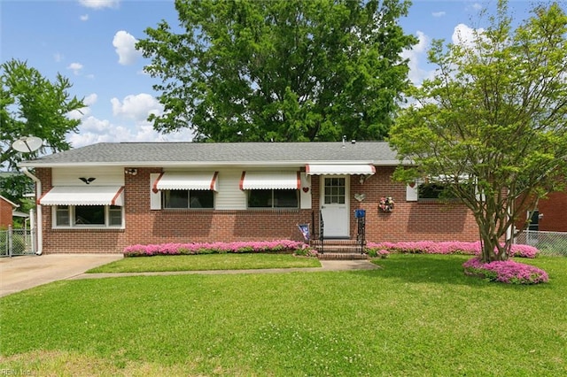 single story home with brick siding, fence, entry steps, and a front yard