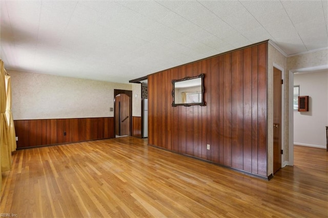 empty room with wood walls and wood finished floors