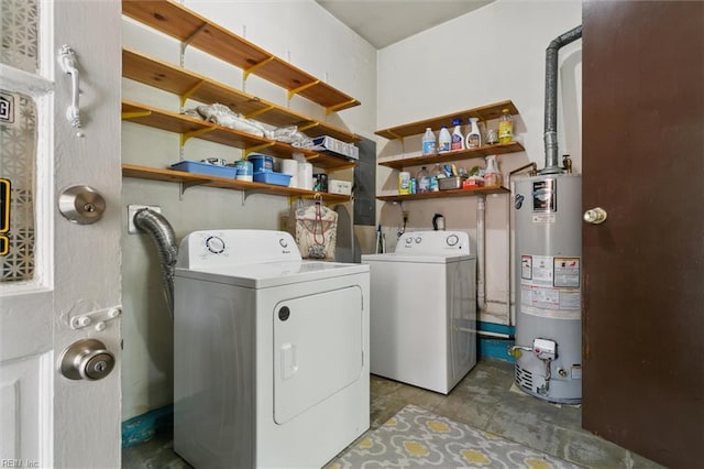 washroom featuring gas water heater, separate washer and dryer, and laundry area