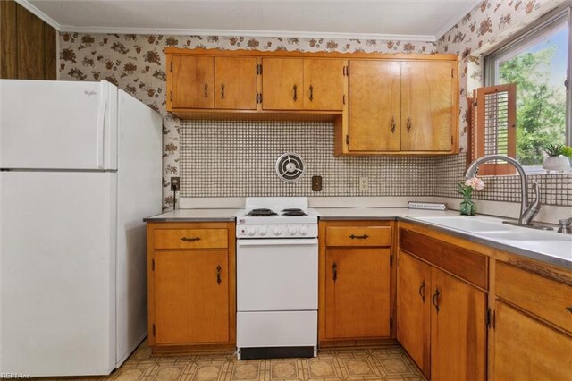 kitchen featuring a sink, wallpapered walls, white appliances, light floors, and light countertops