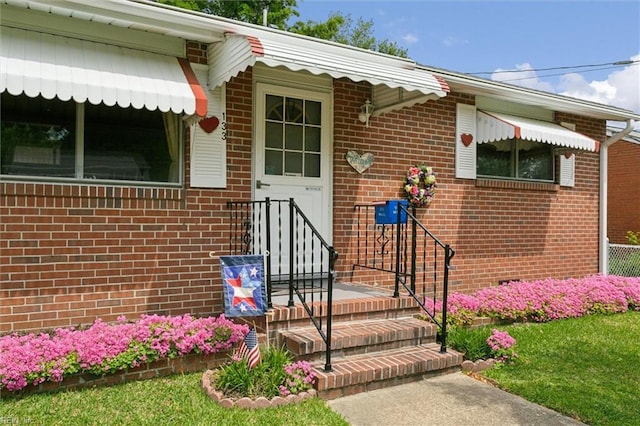 property entrance featuring brick siding
