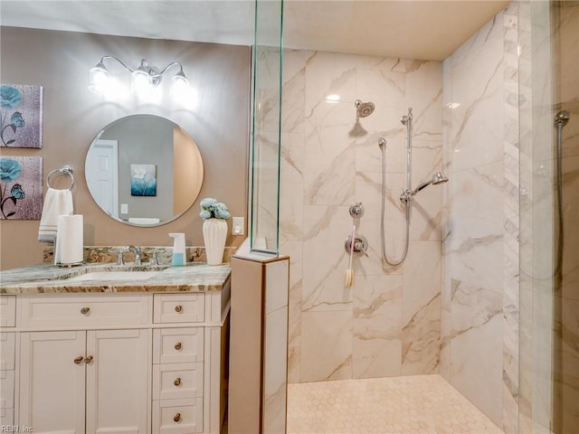 bathroom with a marble finish shower and vanity