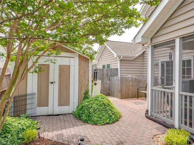 view of shed featuring fence