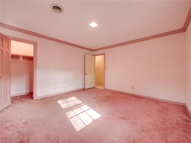 unfurnished bedroom featuring light carpet, ornamental molding, visible vents, and baseboards