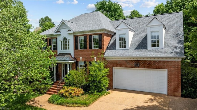 4011 E Providence Rd, Williamsburg, VA 23188 - view of front facade featuring brick siding, driveway, a shingled roof, and a garage