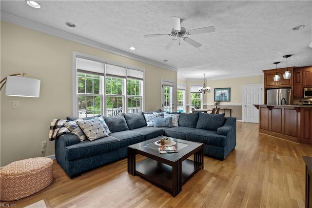 4011 E Providence Rd, Williamsburg, VA 23188 - living room featuring recessed lighting, ornamental molding, ceiling fan with notable chandelier, and light wood-style flooring
