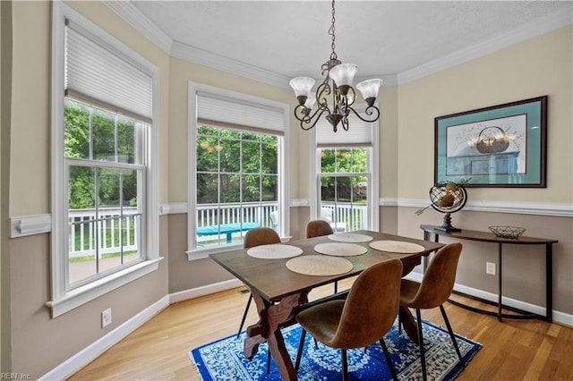 4011 E Providence Rd, Williamsburg, VA 23188 - dining area with light wood-type flooring, a wealth of natural light, an inviting chandelier, and ornamental molding