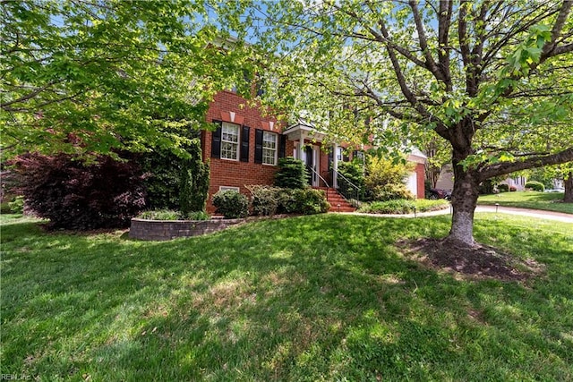 4011 E Providence Rd, Williamsburg, VA 23188 - view of front of home featuring an attached garage, brick siding, and a front yard