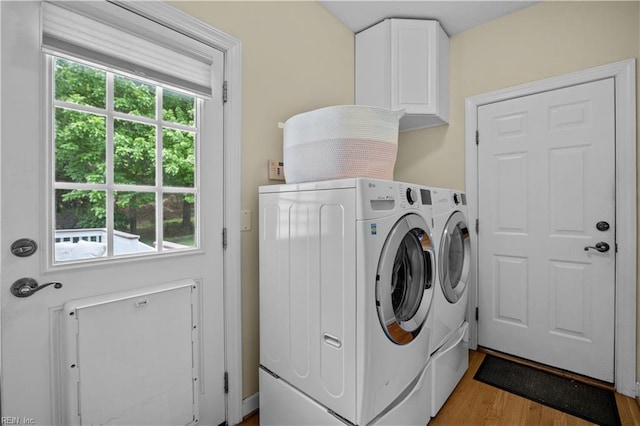 4011 E Providence Rd, Williamsburg, VA 23188 - laundry room with washing machine and dryer, light wood-type flooring, and cabinet space