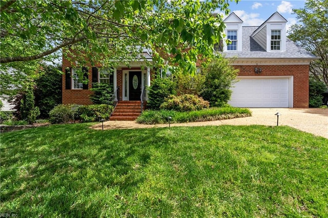 4011 E Providence Rd, Williamsburg, VA 23188 - view of front of home with driveway, brick siding, a front yard, and a garage
