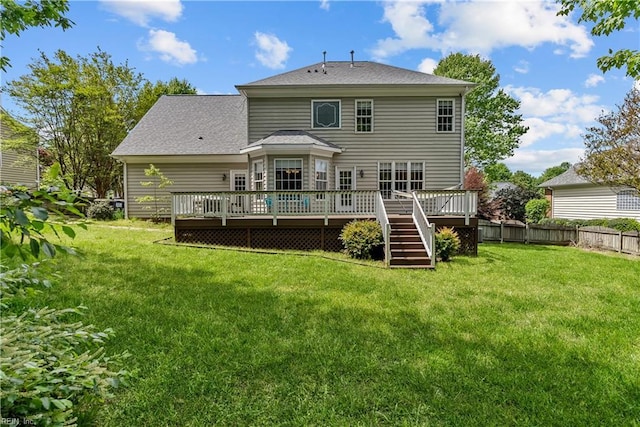 4011 E Providence Rd, Williamsburg, VA 23188 - rear view of house with a yard, fence, a deck, and a shingled roof