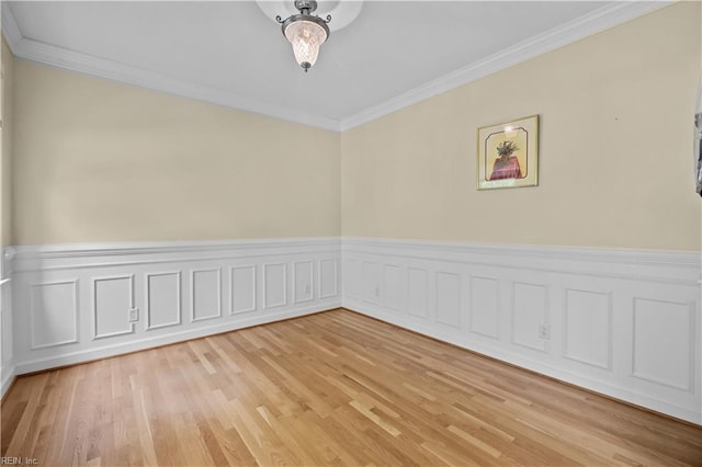 4011 E Providence Rd, Williamsburg, VA 23188 - spare room with light wood-style flooring, a wainscoted wall, and ornamental molding