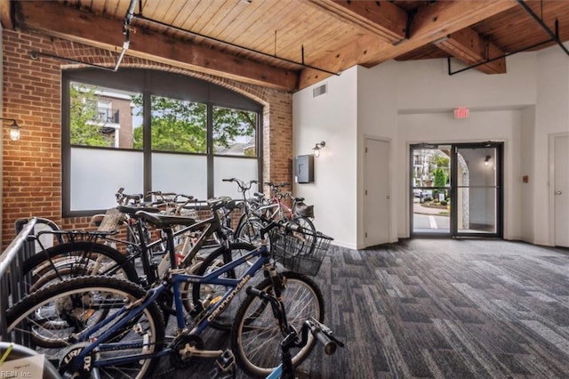 garage featuring visible vents, wooden ceiling, and baseboards