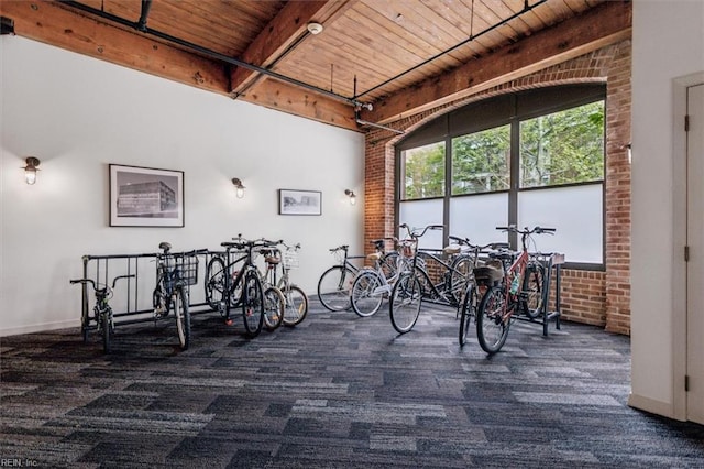 interior space featuring wood ceiling and baseboards