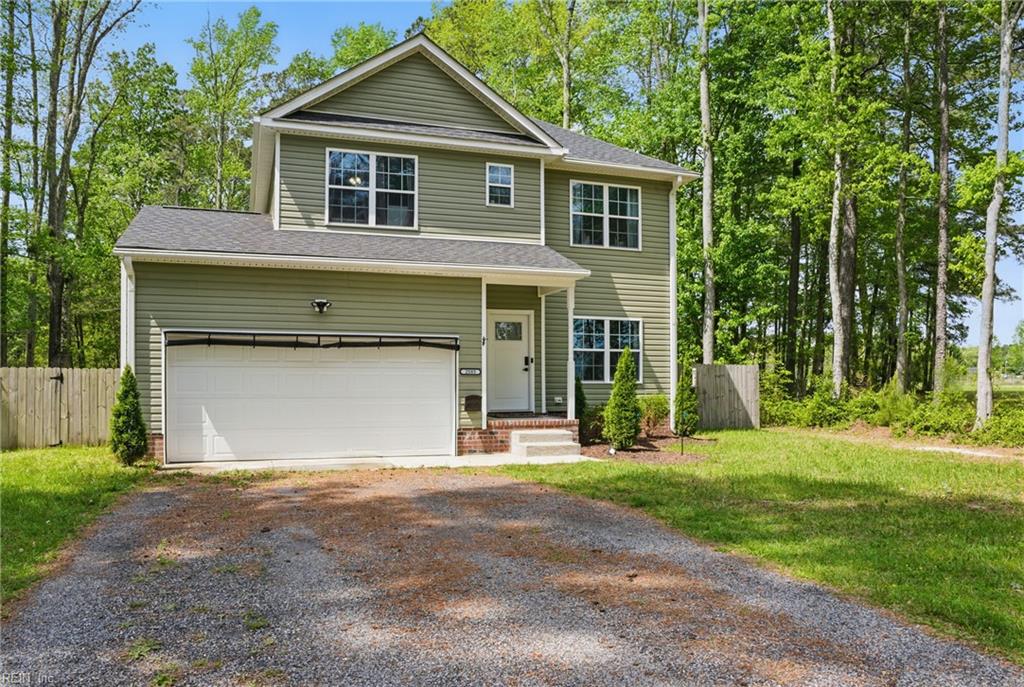 2585 Desert Rd, Suffolk, VA 23434 - view of front of home featuring a front lawn, driveway, a shingled roof, fence, and a garage